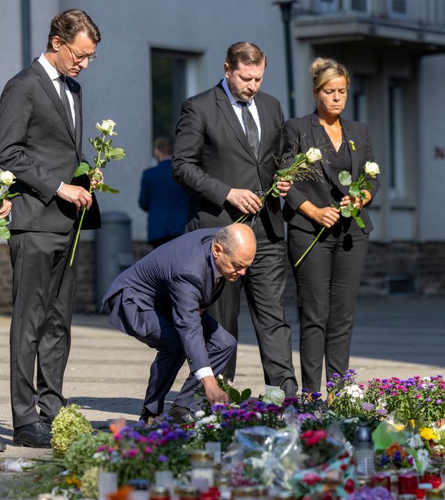 Olaf Scholz legt zusammen mit anderen Politikern Blumen in Solingen nieder