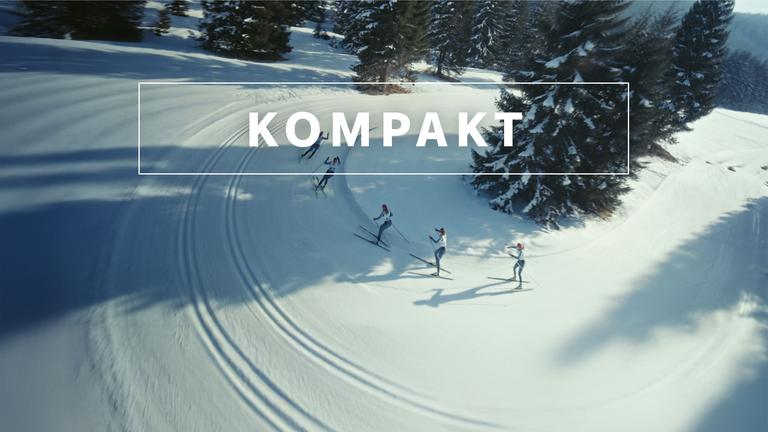 Das Wintersport "KOMPAKT"- Logo vor Langläufern auf der Strecke