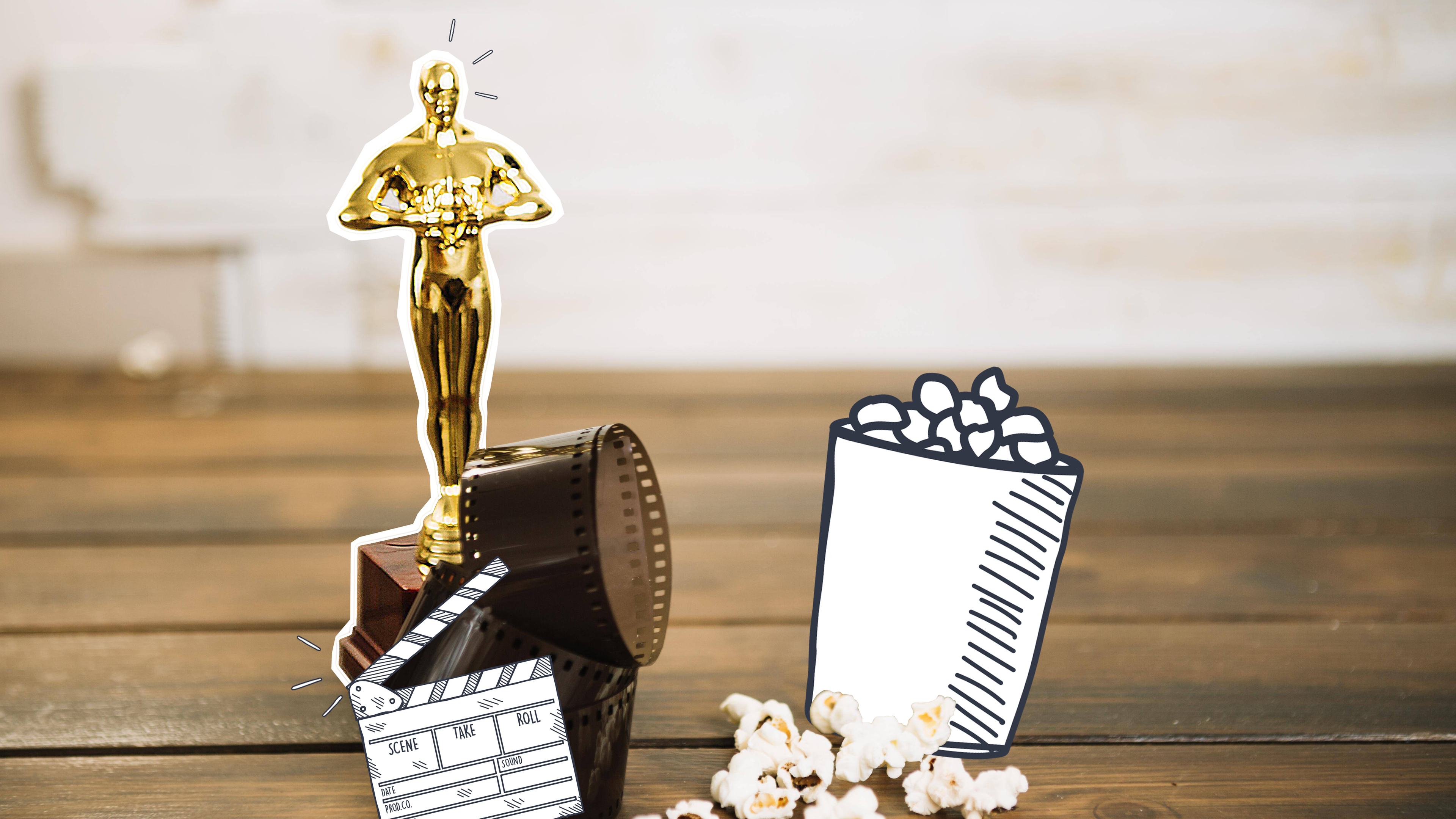 Man sieht einen Oscar, der auf einem Holzboden steht. Davor liegt eine Filmrolle. Neben dem Oscar liegt Popcorn. 