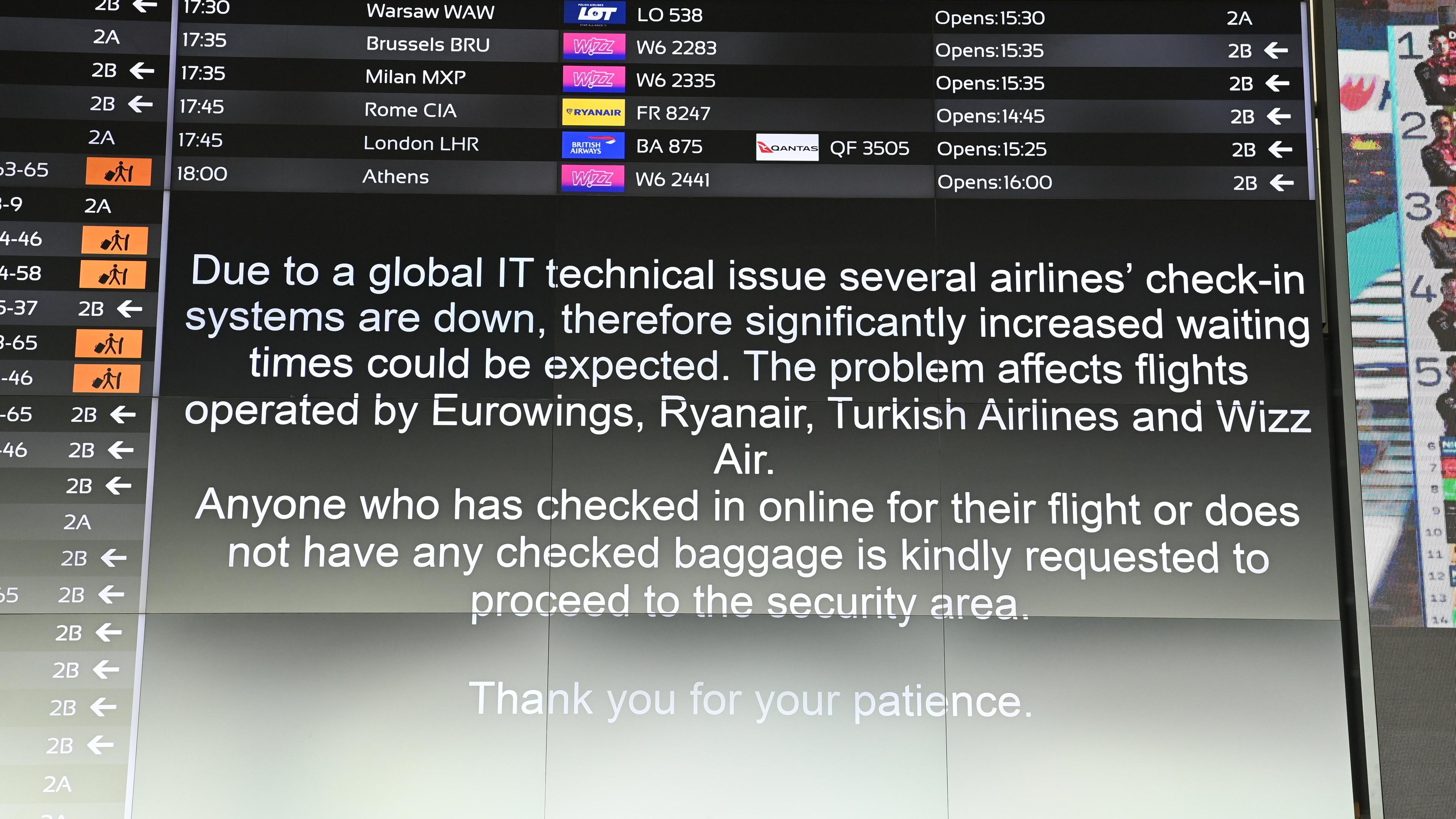 A message informs passengers in the departure hall at Liszt Ferenc International Airport in Budapest, Hungary, 19 July 2024, as companies and institutions around the world have been hit by a major global IT outage. At Budapest Airport, Eurowings, Ryanair, Turkish Airlines and Wizz Air flights have been affected due to disruptions to the passenger check-in system, causing flight delays and longer wait times. Several airlines have switched to manual passenger check-in at the airport. Companies and institutions around the world have been affected on 19 July by a major computer outage in systems running Microsoft Windows linked to a faulty CrowdStrike cyber-security software update.