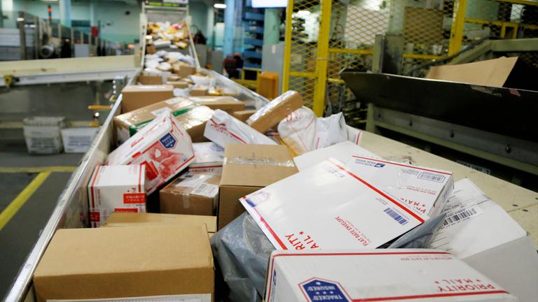 Symbolbild: Laufband mit Paketen in US-Postamt