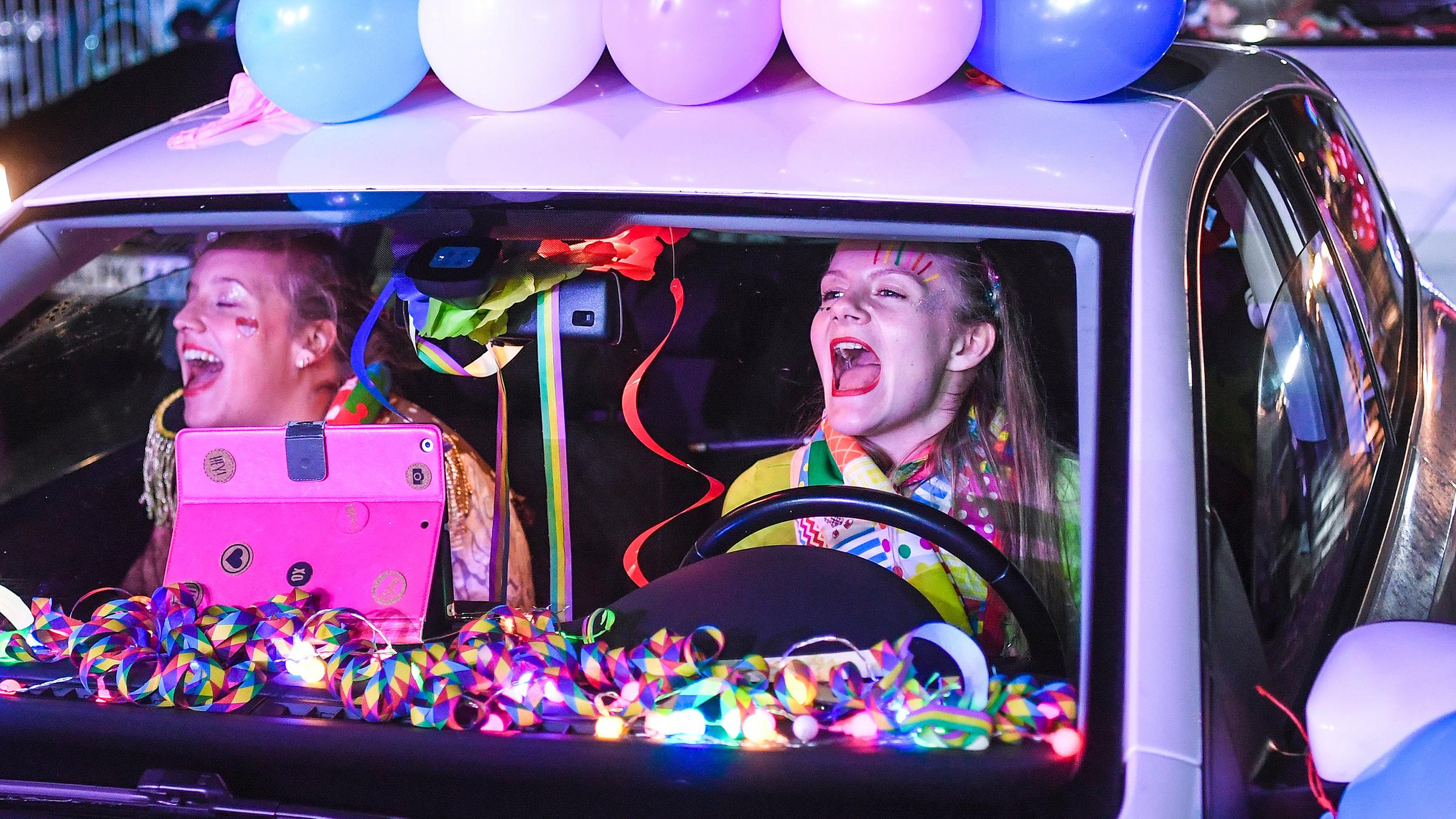 Teilnehmerinnen in ihrem Auto bei einem Karnevalskonzert in einem Bonner Autokino.