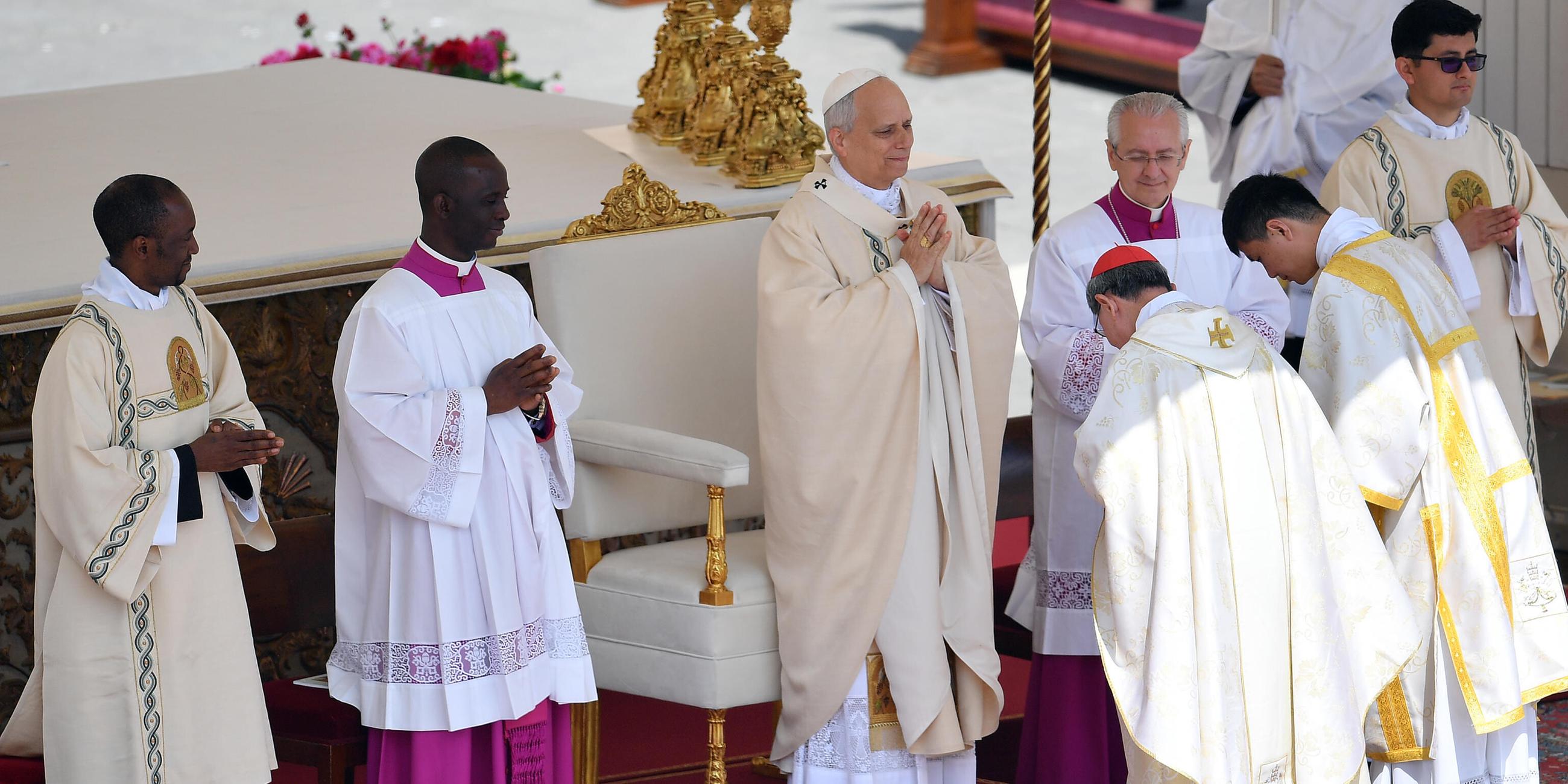 Filipino cardinal Luis Antonio Gokim Tagle puts the Fisherman s Ring on the finger of Pope Leo XIV during a mass for the beginning of his pontificate, in St Peter s square.