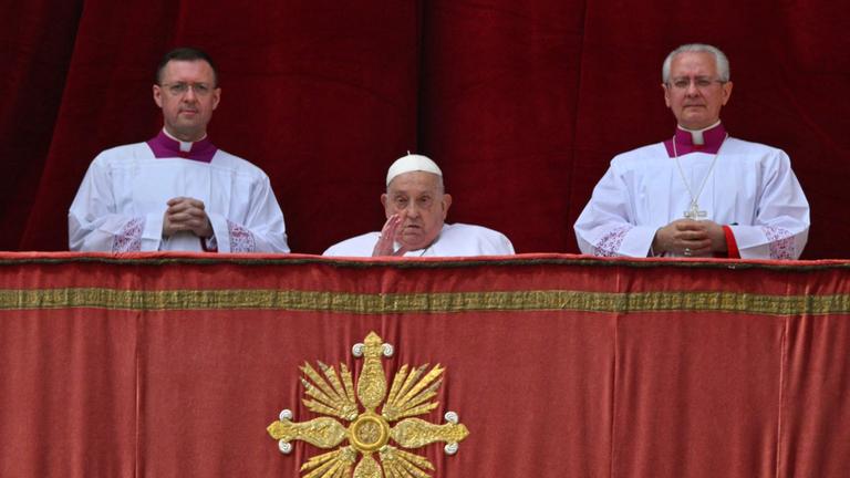 Pope Francis appears at the main balcony of St. Peter's basilica before the Urbi et Orbi message and blessing to the city and the world as part of Easter celebrations, at St Peter's square in the Vatican on April 20, 2025.