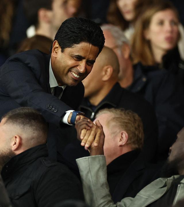 Paris-Saint-Germain-Chef Nasser Al-Khelaifi (links) begrüßt beim Spiel Paris Saint-Germain - Stade Rennes einen anderen Tribünengast per Handschlag