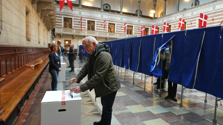 Ein Mann bei der Stimmabgabe in einem Wahllokal im Rathaus von Kopenhagen während der Parlamentswahl
