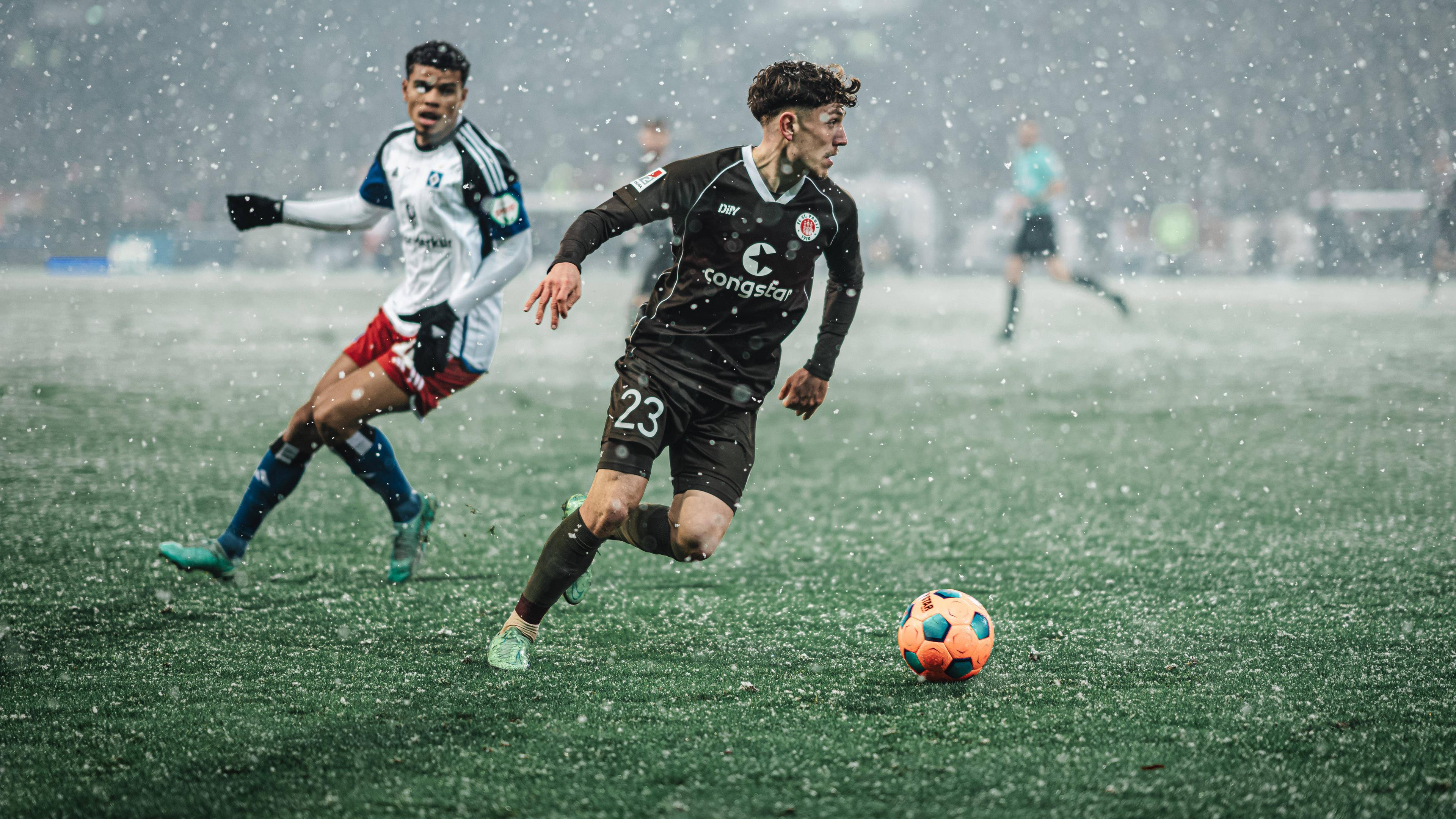 FC St. Pauli - Hamburger SV am 01.12.2023: Philipp Treu (FC St. Pauli) am Ball gegen einen Hamburger Gegenspieler.