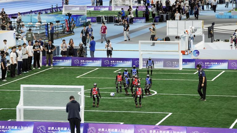 Humanoid robots play football at the World Humanoid Robot Games in Beijing.