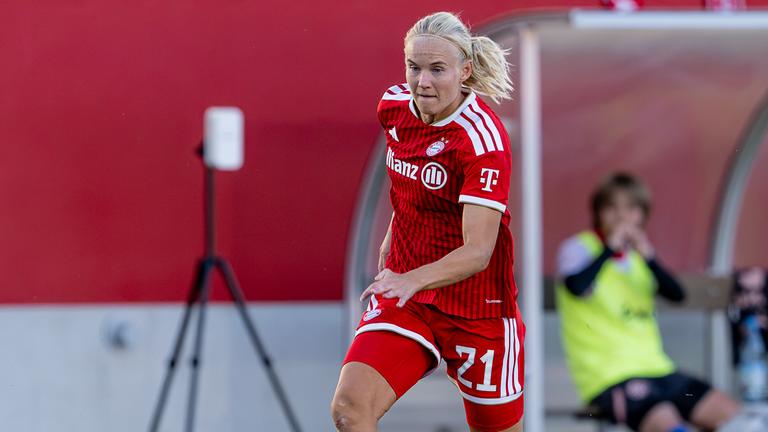 Fussballerin Pernille Harder setzt im roten Bayern-München-Trikot zu einem Dribbling an. 