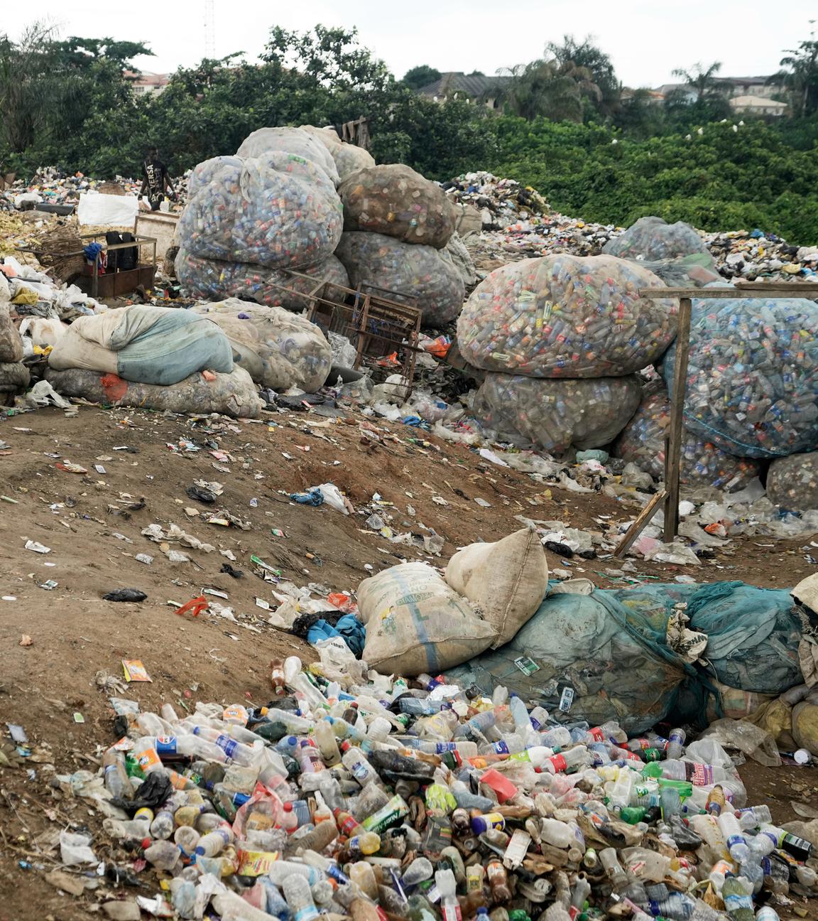 Scavengers sort out plastic waste at a dumpsite on the outskirts of Lagos, Nigeria, Monday, Aug 11, 2025.