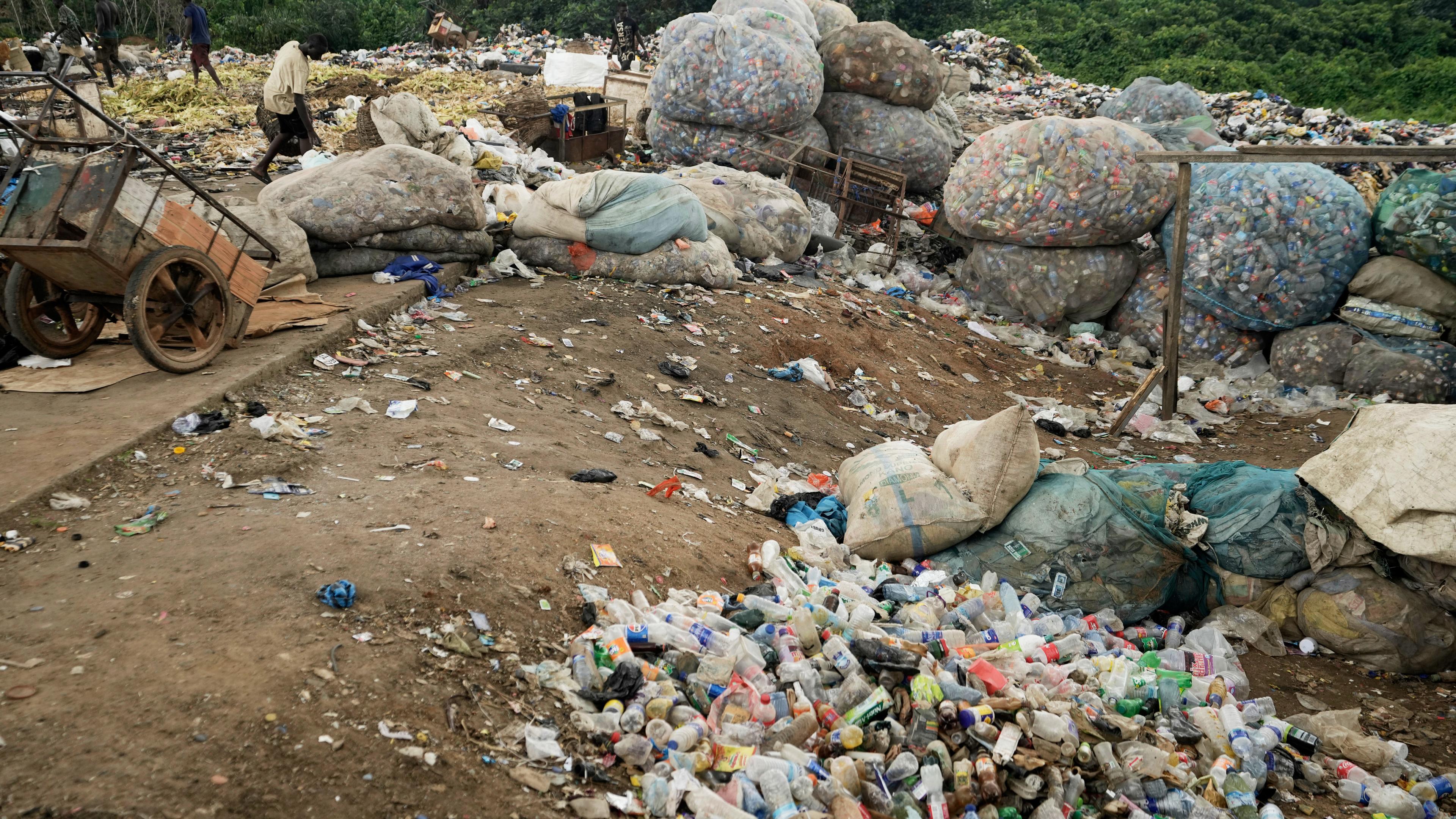 Scavengers sort out plastic waste at a dumpsite on the outskirts of Lagos, Nigeria, Monday, Aug 11, 2025.