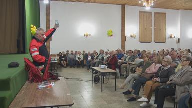 Menschen in einer Halle werden geschult, was sie in Krisensituationen tun müssen.