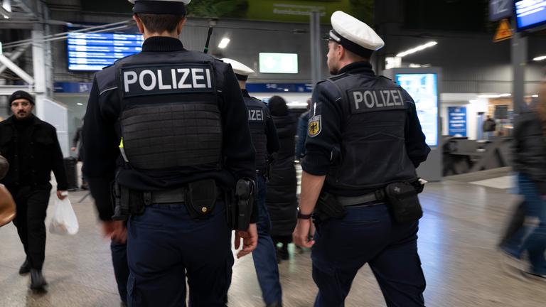 Polizisten gehen während eines Schwerpunkteinsatz der Bundespolizei am Münchner Hauptbahnhof durch die Halle.