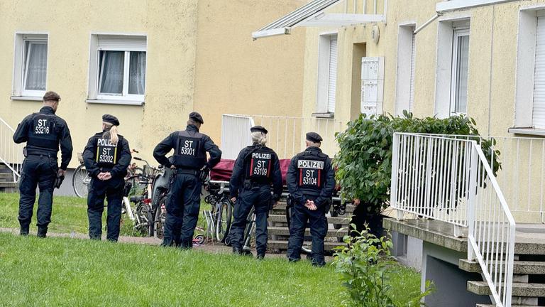Polizisten stehen an einem Einsatzort, der möglichwerweise im Zusammenhang mit der Attacke in Wolmirstedt steht