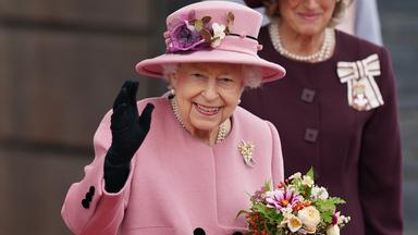  Großbritannien, Cardiff: Die britische Königin Elizabeth II. hält einen Blumenstrauß in der Hand und winkt, nachdem sie nach der Eröffnungszeremonie des walisischen Parlaments das Parlamentsgebäude verlässt.