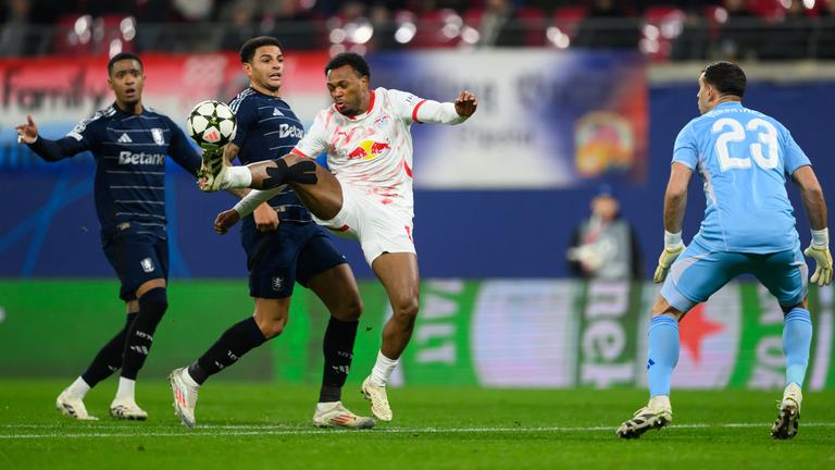 Fußball-Champions League, RB Leipzig - Aston Villa: Lois Openda (3.v.l.) staubt gegen Ezri Konsa (l.), Diego Carlos (2.v.l.) und Torwart Emiliano Martinez ab und macht sich auf den Weg, das Tor zum 1:1 zu erzielen.