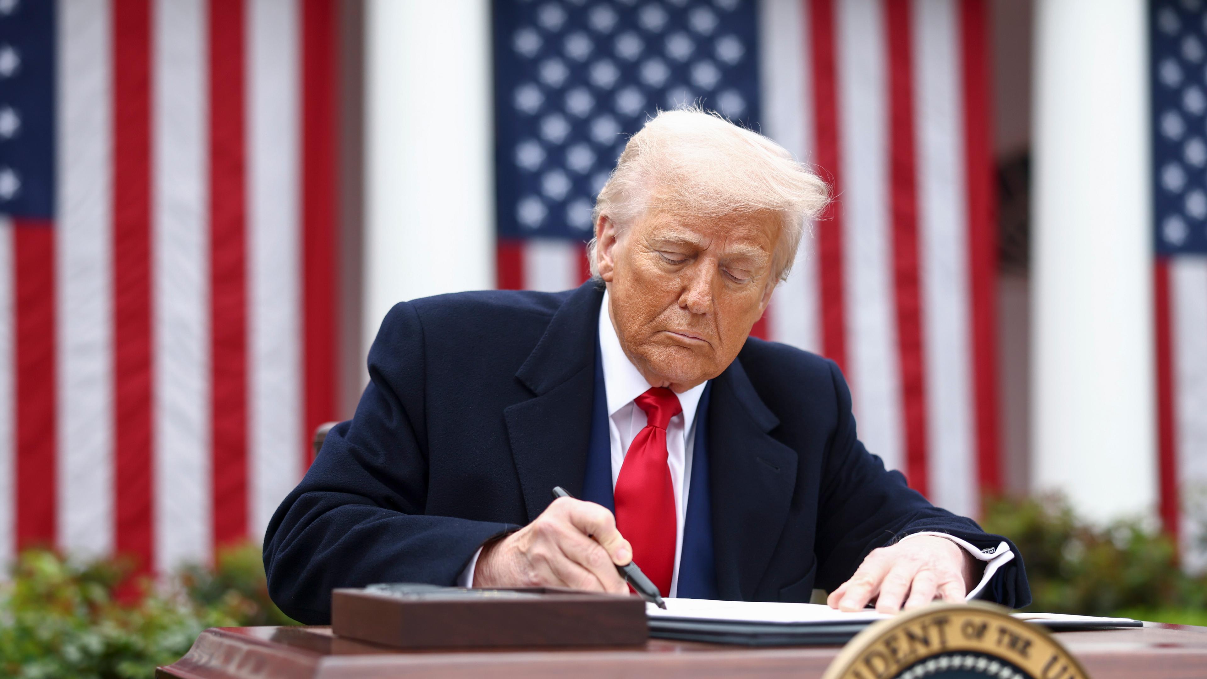 US President Donald Trump signs an executive order implementing new reciprocal tariffs against US trading partners in the Rose Garden of the White House in Washington, DC, USA, 02 April 2025.
