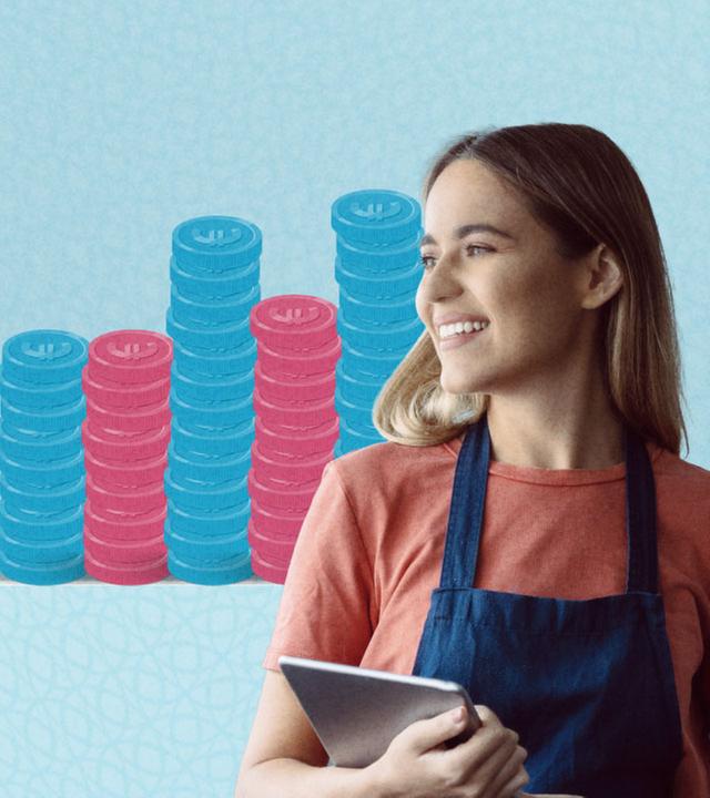 Eine junge Frau ist vor Münzstapeln zu sehen - Symbolbild zum Mindestlohn