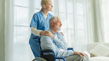 Help support retirement healthcare. Nurse helping old man in wheelchair. Patient and woman in nursing home for medical caregiver, Nurse taking care of paralyzed man in chair for people with disability