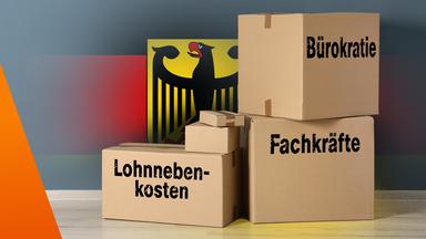 Bundesadler mit Kartons, darauf stehen: Lohnnebenkosten, Fachkräfte und Bürokratie