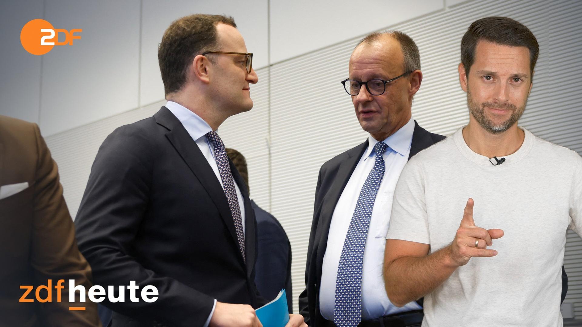 Jens Spahn und Friedrich Merz stehen sich gegenüber und machen ein nachdenkliches Gesicht. Im Vordergrund rechts ist Mirko Drotschamann zu sehe, er hebt einen Finger, um den Rentenstreit der Union zu einzuordnen