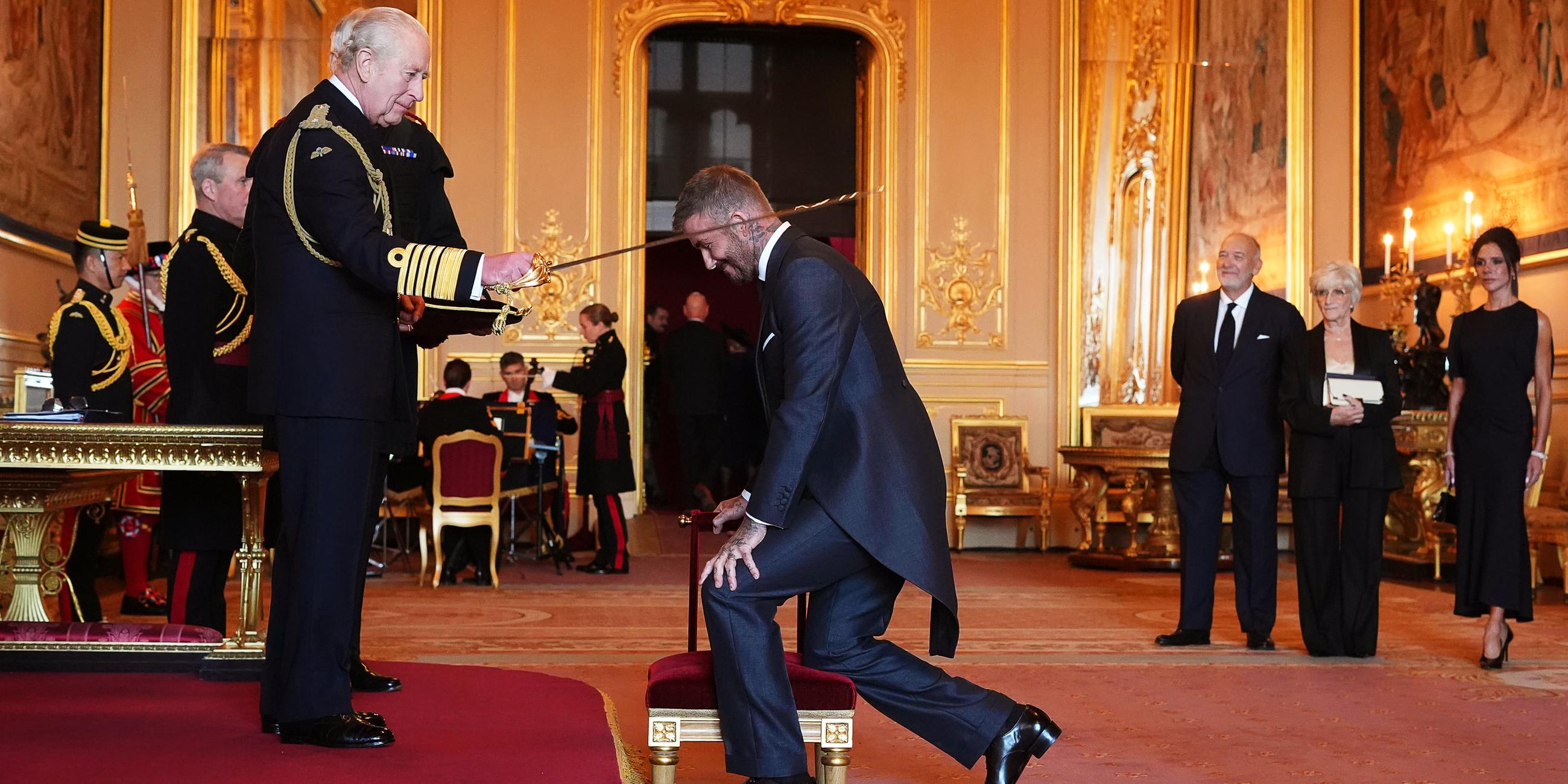 Sir David Beckham (Mitte) wird von König Charles III. (links) während einer Zeremonie auf Schloss Windsor in den Ritterstand erhoben.