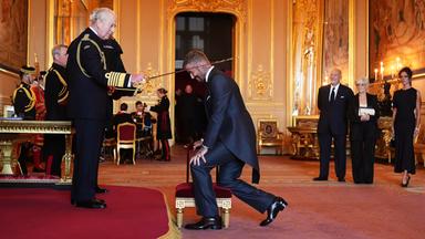 Sir David Beckham (Mitte) wird von König Charles III. (links) während einer Zeremonie auf Schloss Windsor in den Ritterstand erhoben.