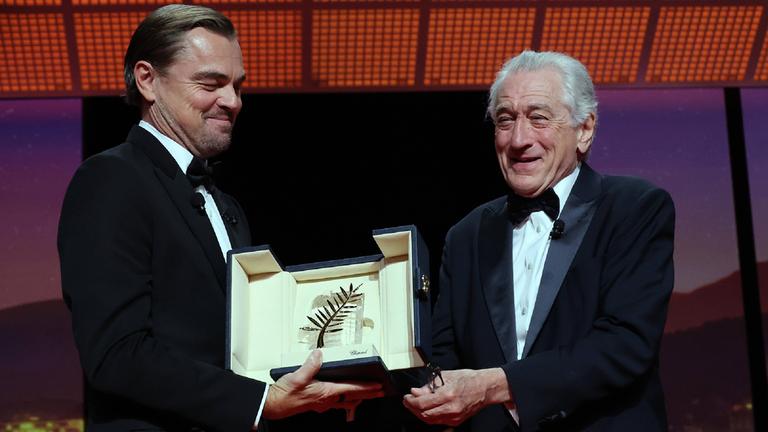 Der Schauspieler Robert De Niro bekommt die Goldene Ehrenpalme bei den Filmfestspielen von Cannes von Leonardo Di Caprio überreicht.
