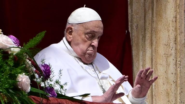 Pope Francis waves from the main balcony of St. Peter's basilica during the Urbi et Orbi message and blessing to the city and the world as part of Easter celebrations, at St Peter's square in the Vatican.