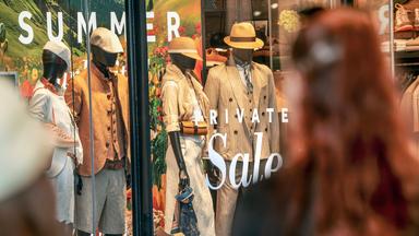 Zwei Frauen stehen im Juni 2025 vor einem Modegeschäft und betrachten das Schaufenster in der Theatinerstraße in München. 