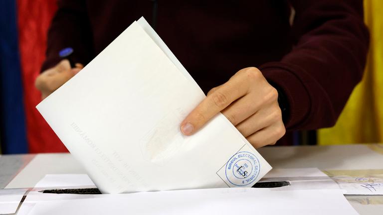 A Romanian man casts his ballot in the second round of presidential elections at a polling station in Bucharest.