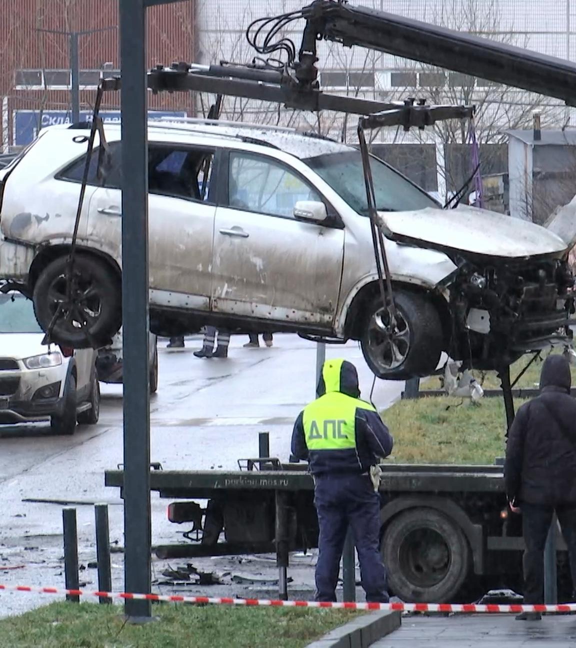 Auf diesem aus einem Video aufgenommenen Foto beobachten Ermittler und Polizisten, wie ein Kran ein durch eine Explosion beschädigtes Auto auf eine Plattform am Tatort verlädt, wo Generalleutnant Fanil Sarvarov, Leiter der Operationsausbildungsdirektion des Generalstabs der russischen Streitkräfte, am Montag, dem 22. Dezember 2025, in Moskau durch einen unter seinem Auto platzierten Sprengsatz getötet wurde.