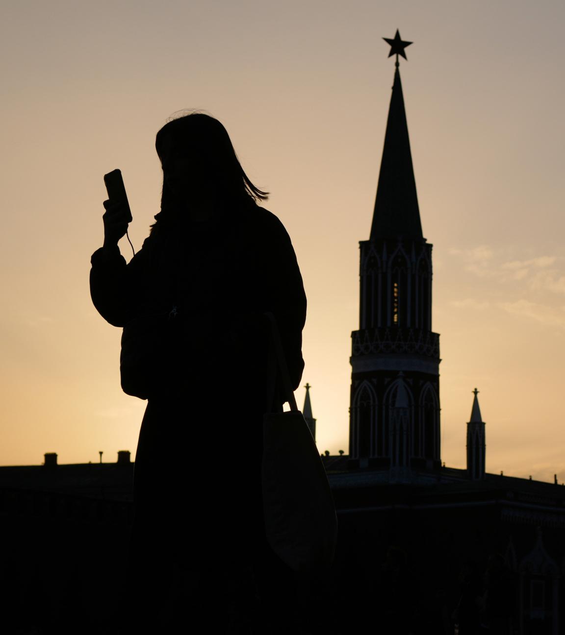Umriss einer Person mit Handy in der Hand auf dem Roten Platz in Moskau