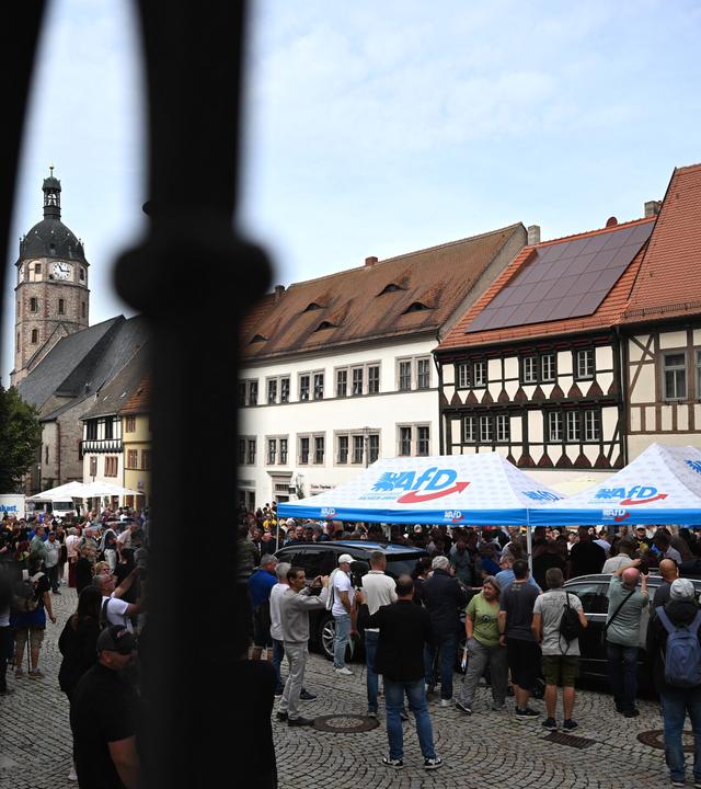 28.08.2026, Sachsen-Anhalt, Sangerhausen: Besucher eines Wahlkampfstandes der AfD auf dem Marktplatz in Sangerhausen stehen in einer Schlange vor dem Zelt mit dem Spitzenkandidaten Siegmund.