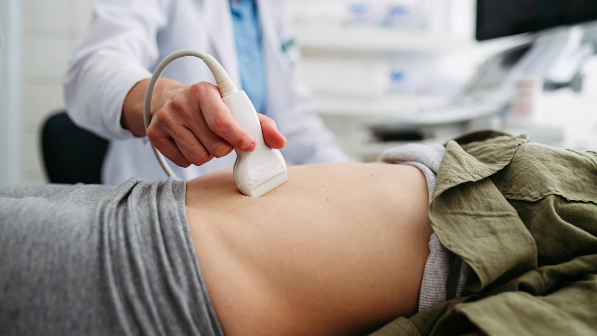 Eine Gynäkologin untersucht eine Patientin mit einem Ultraschallgerät.