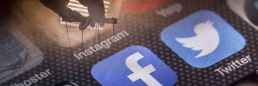  Computergrafik: Darstellung verschiedener Apps und darüber die Hand eines Puppenspielers.