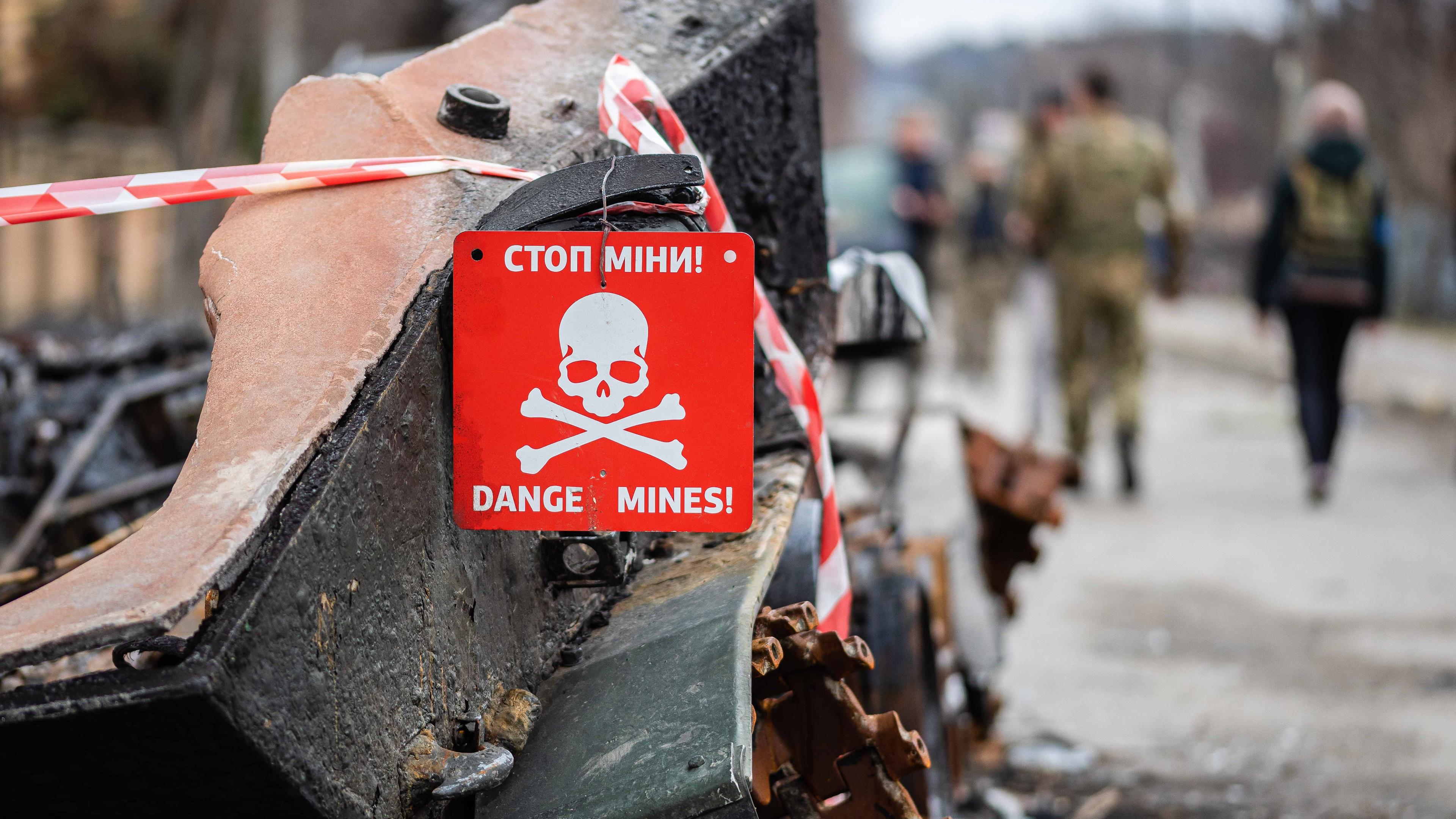 Ukraine, Butscha: Ein Schild mit der Aufschrift "Stop Minen, Danger Mines"