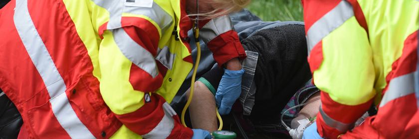 Helfer einer First Responder Einheit demonstrieren bei einer Einsatzübung auf einem Feldweg die versorgung eines patienten
