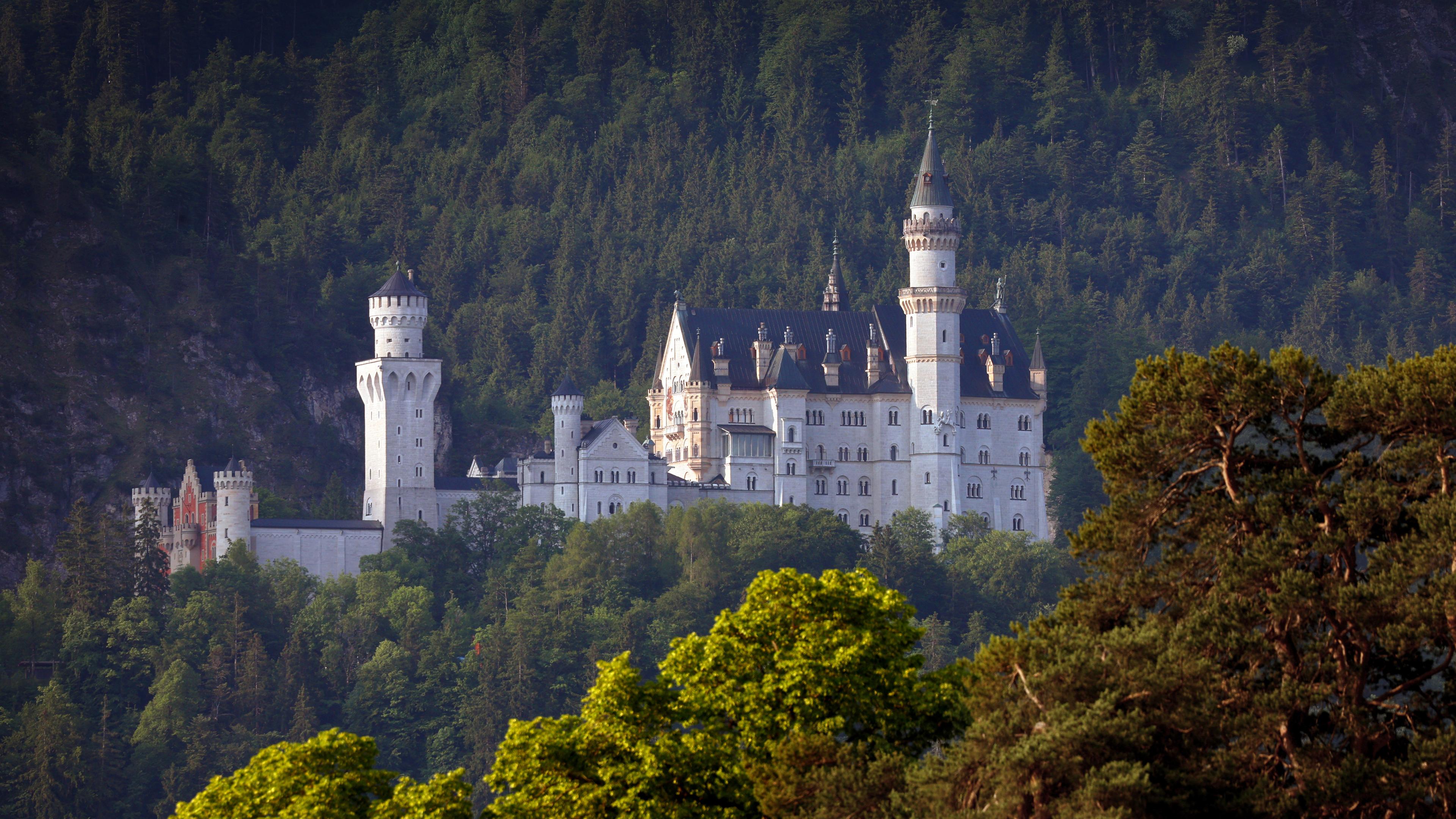 Bayern, Schwangau: Das Schloss Neuschwanstein im Morgenlicht.