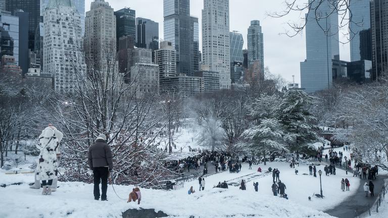 Menschen spazieren im schneebedeckten Central Park in New York City 