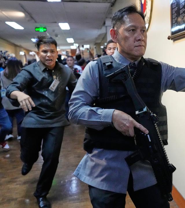 Sicherheitskräfte des Senats rennen los, nachdem in einem Korridor des philippinischen Senats in Pasay (Philippinen) Schüsse zu hören waren.