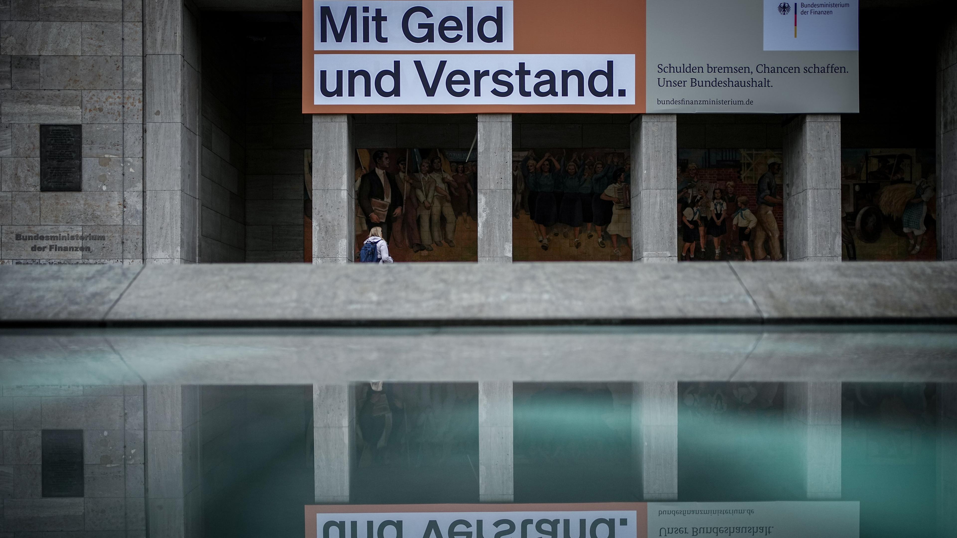  Ein Plakat mit der Aufschrift "Mit Geld und Verstand. Schulden bremsen, Chancen schaffen. Unser Bundeshaushalt." hängt über dem Eingang zum Bundesministerium der Finanzen.