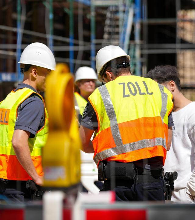 Archiv: Zollbeamte kontrollieren während einer Prüfmaßnahme der Finanzkontrolle Schwarzarbeit auf eine Berliner Baustelle einen Arbeiter. 