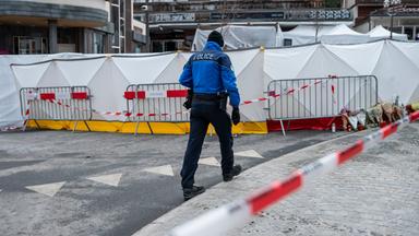 Schweiz, Crans-Montana: Ein Polizist der Walliser Kantonspolizei sichert den Bereich vor der abgesperrten Bar und Lounge "Le Constellation"