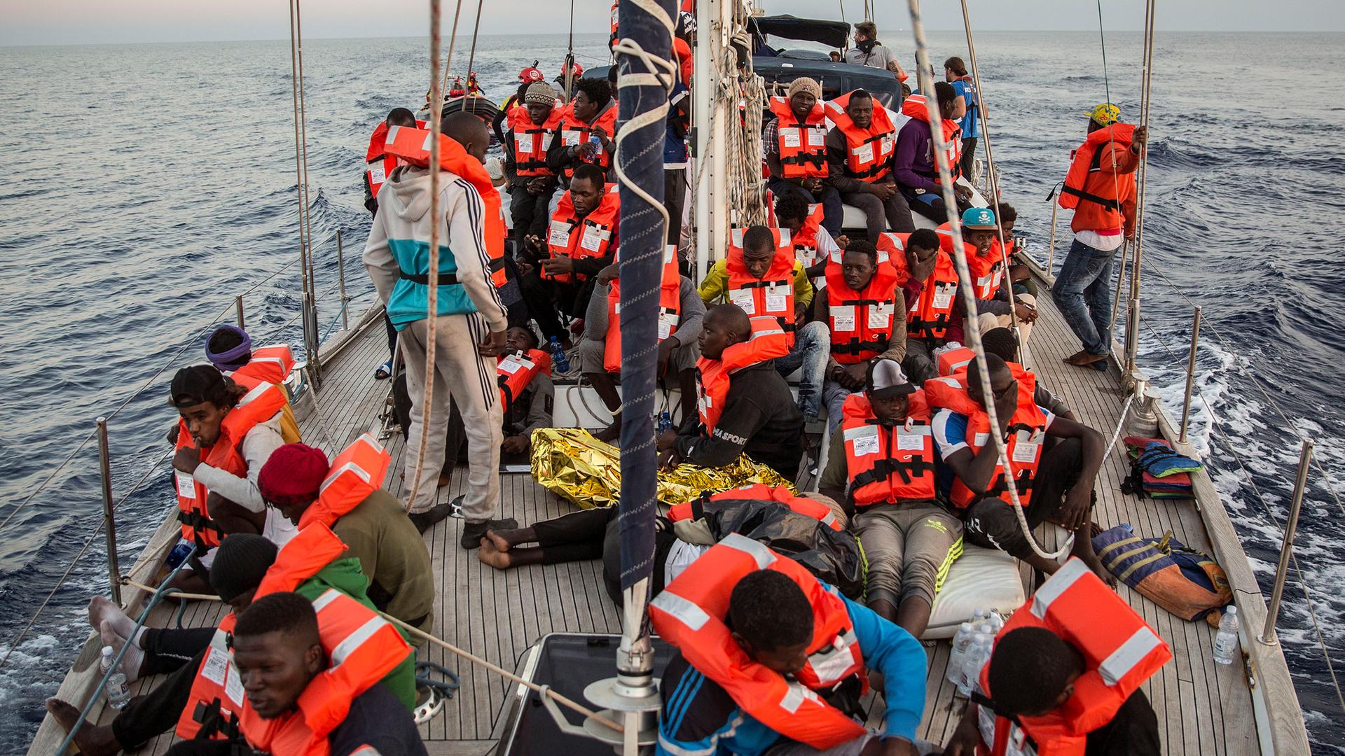 Archiv: Flüchtlinge sitzen auf einem Boot der Hilfsorganisation "Mediterranea Saving Humans" am 04.07.2019