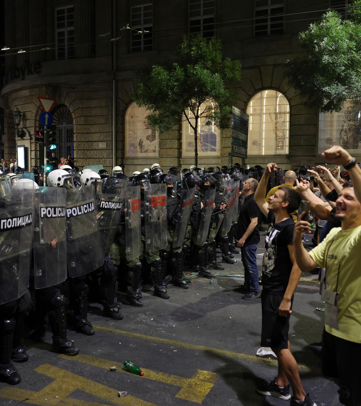 Riot police block a street to prevent clashes between anti-government protesters and government supporters at the end of a rally pressing for an early election after nearly eight months of almost daily anti-corruption demonstrations that have shaken the populist government of President Aleksandar Vucic.
