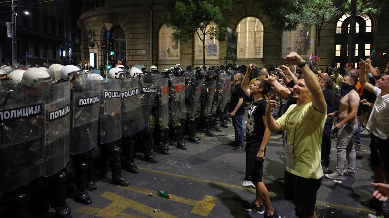 Riot police block a street to prevent clashes between anti-government protesters and government supporters at the end of a rally pressing for an early election after nearly eight months of almost daily anti-corruption demonstrations that have shaken the populist government of President Aleksandar Vucic.