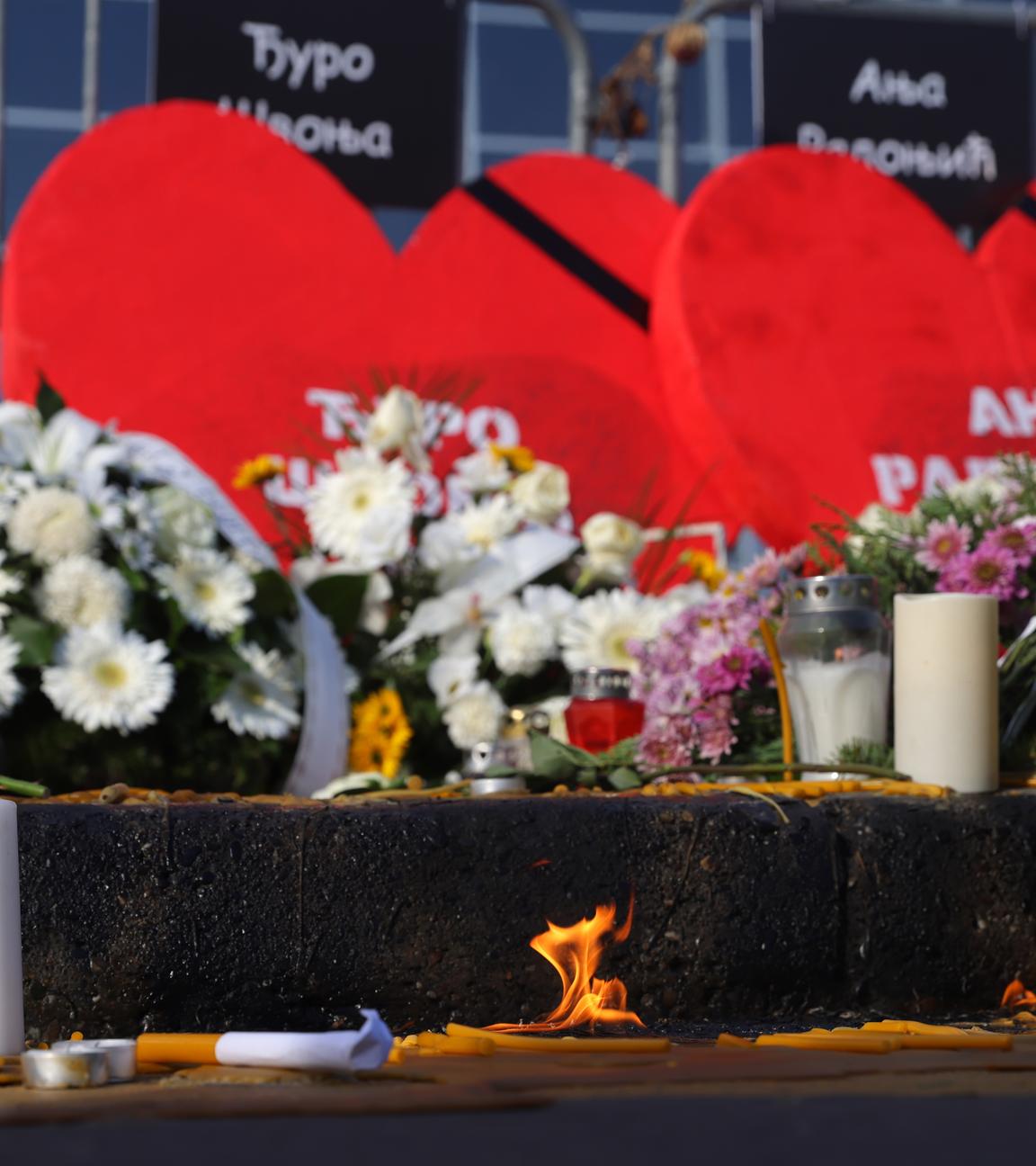 Candles burn in front of the Novi Sad train station during the commemoration in Novi Sad