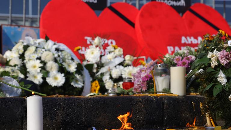 Candles burn in front of the Novi Sad train station during the commemoration in Novi Sad