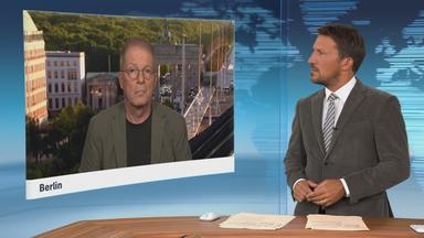 Schaltgespräch mit Klaus Brodbeck und Moderation.